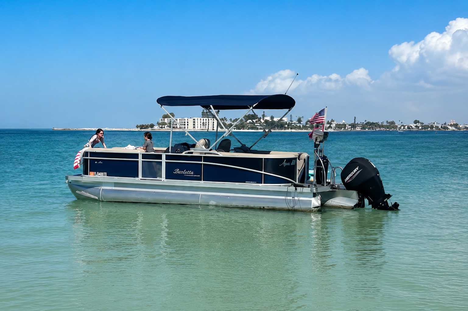 The Agua Blu Charters 2024 Barletta pontoon anchored in calm turquoise Gulf water near St. Petersburg